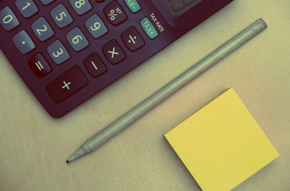 Calculator and pencil used to work out the cost of a basic cremation