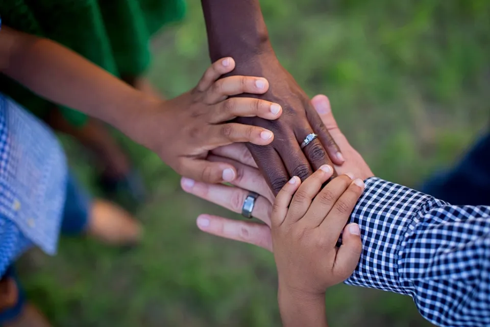 Family members joining hands, supporting each other with funeral costs